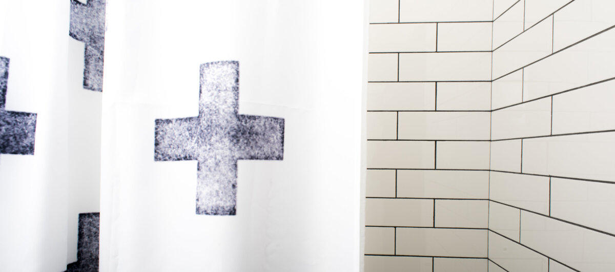 Close up of subway tile shower wall and curtain