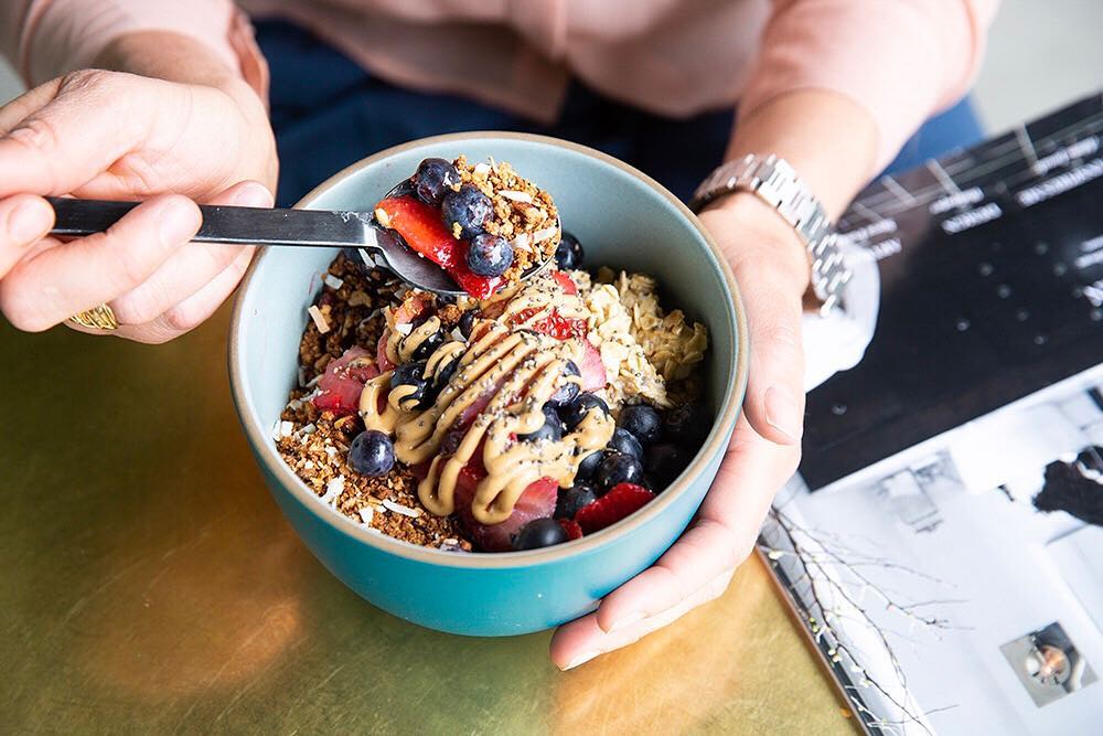 Bowl with granola, berries and peanut butter sauce