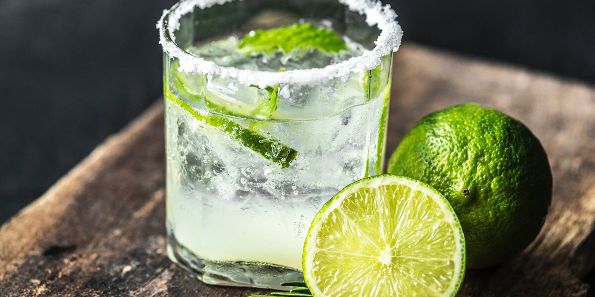 Cocktail with salt rimmed glass and lime