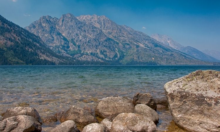 Shot of Jenny Lake in foreground, Grand Tetons in background.