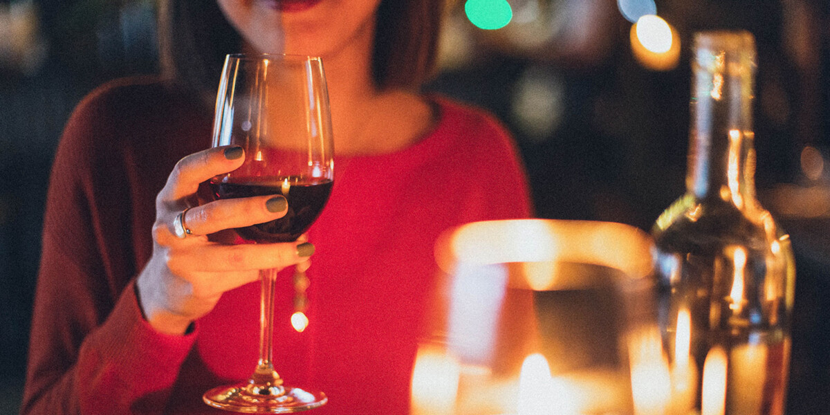 Woman with glass of red wine at restaurant
