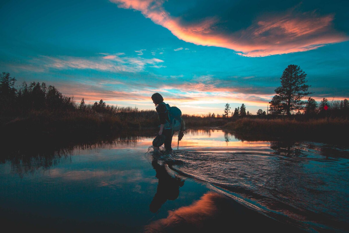Wading In The River At Sunset
